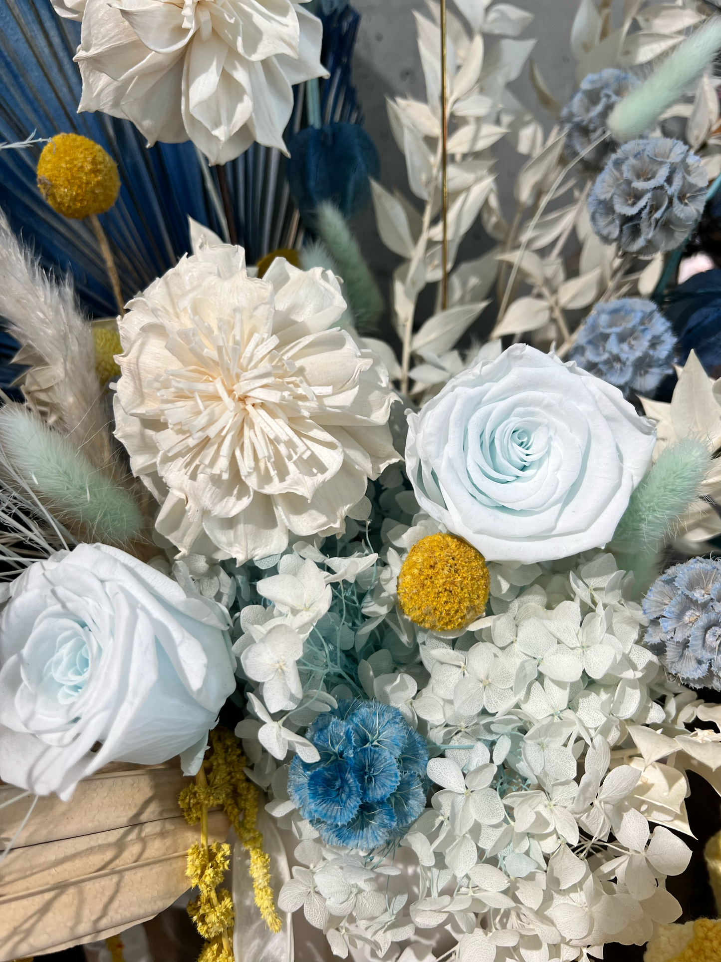 Preserved blue roses, preserved hydrangeas and complementary blue and white everlasting flowers, showcasing premium preserved floral materials for floral design.