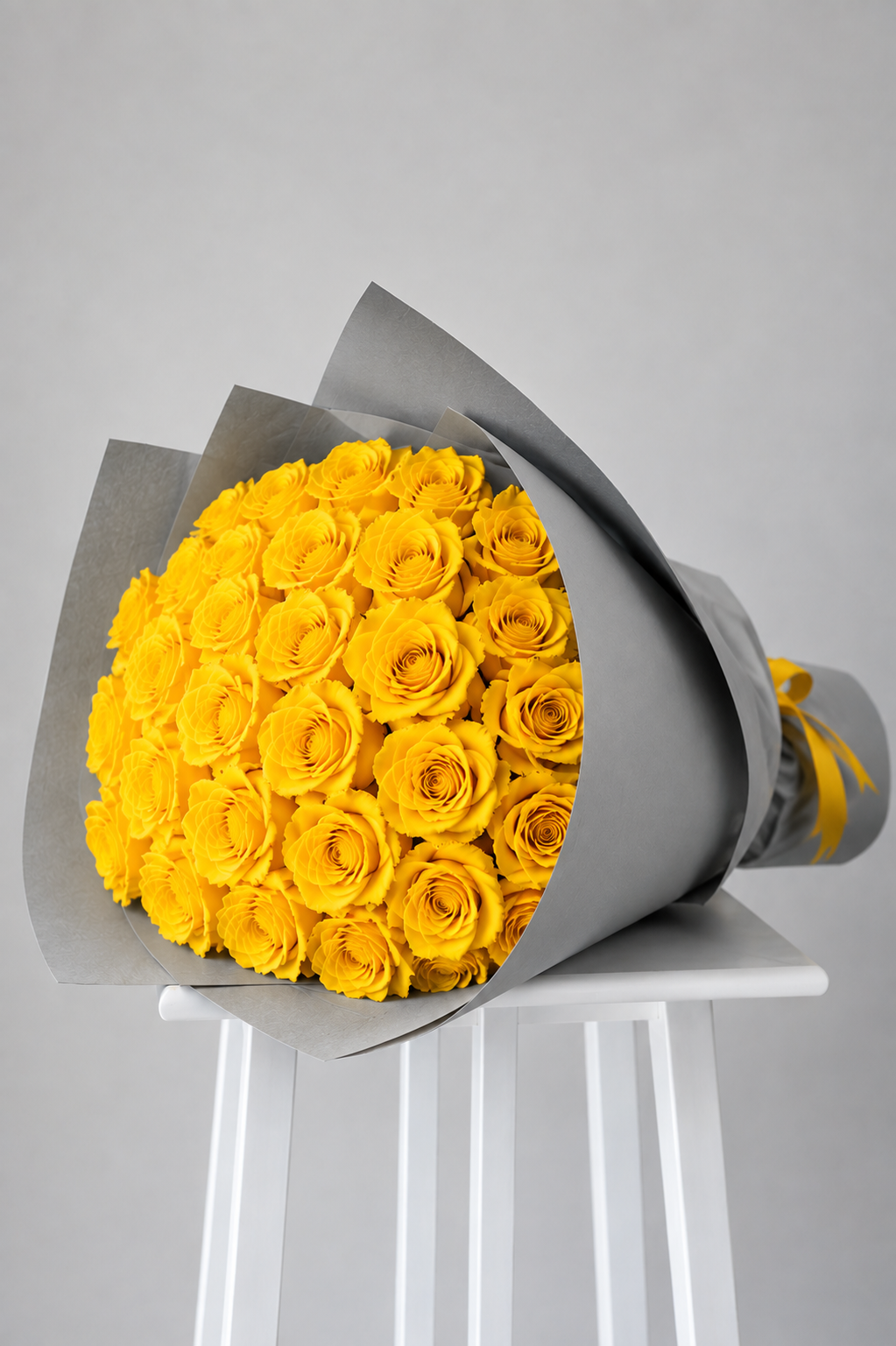 Premium Ecuadorian yellow rose bouquet wrapped in elegant grey paper, handcrafted by Rosella Florist Canberra.