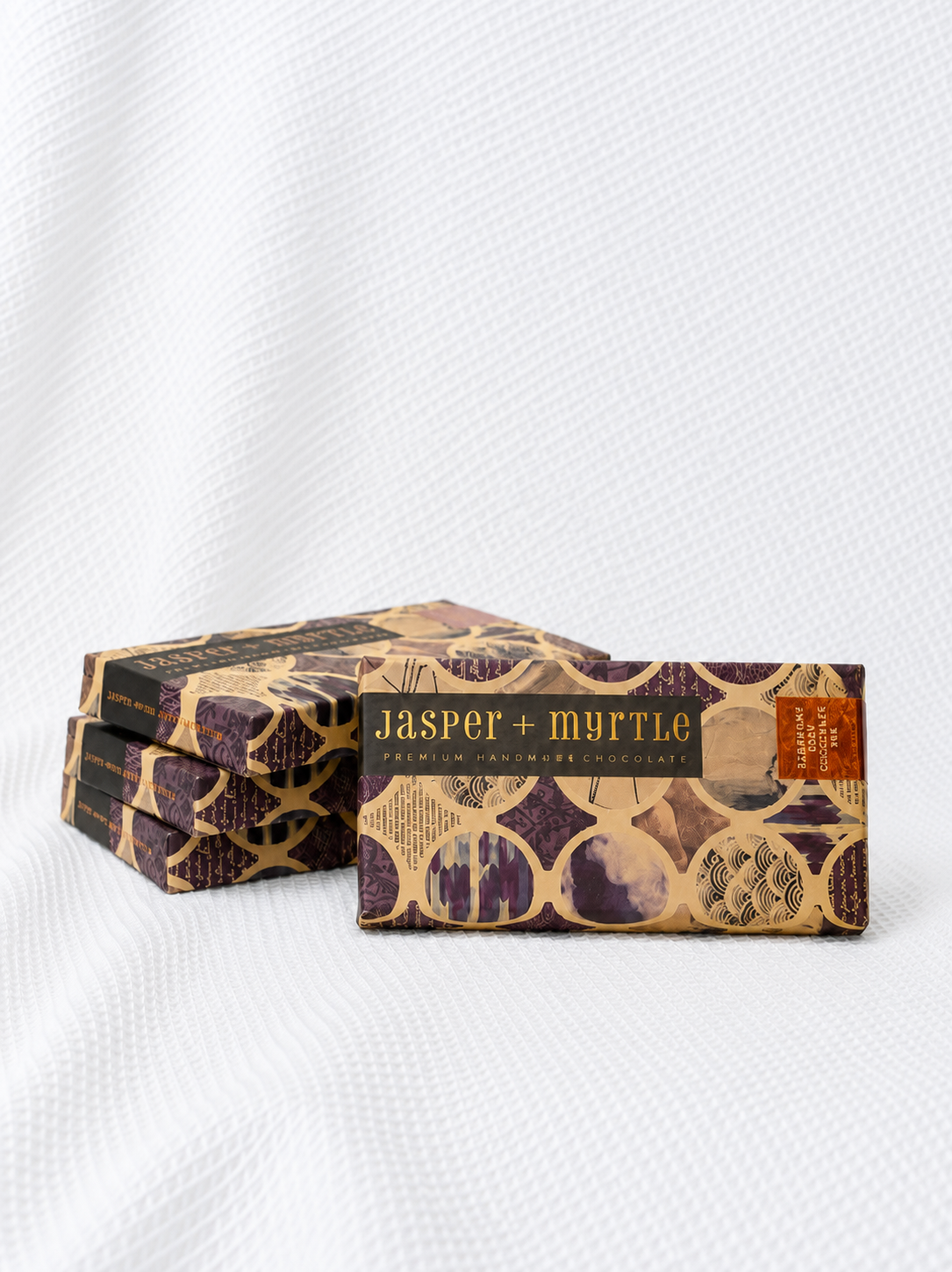 Four Jasper + Myrtle artisan blueberry chocolate bars in purple patterned packaging, a premium gourmet gift add-on from Rosella Florist Canberra.