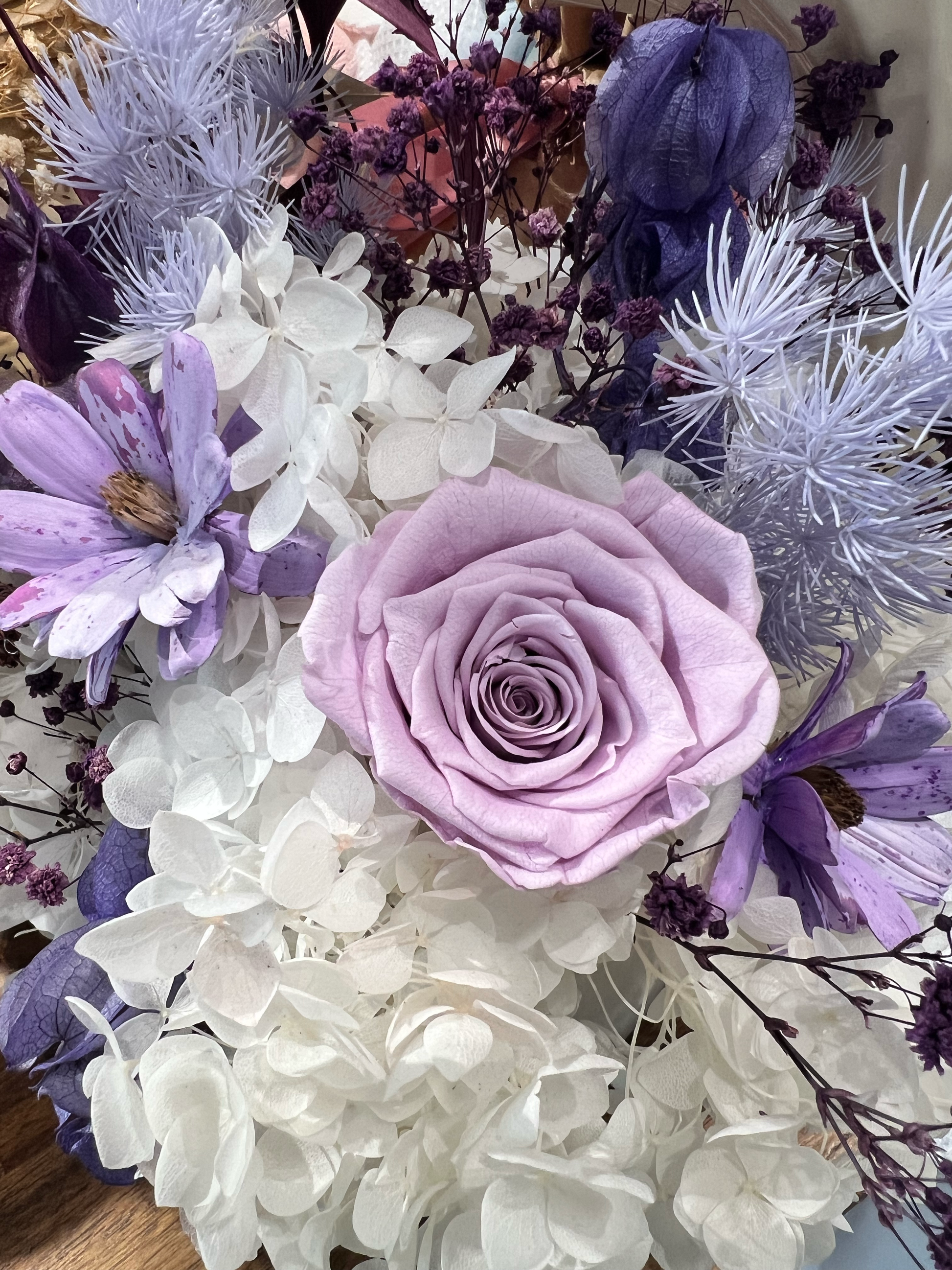 Preserved purple roses with white and purple hydrangeas and coordinating purple and white everlasting flowers, showcasing premium preserved floral materials for floral design.