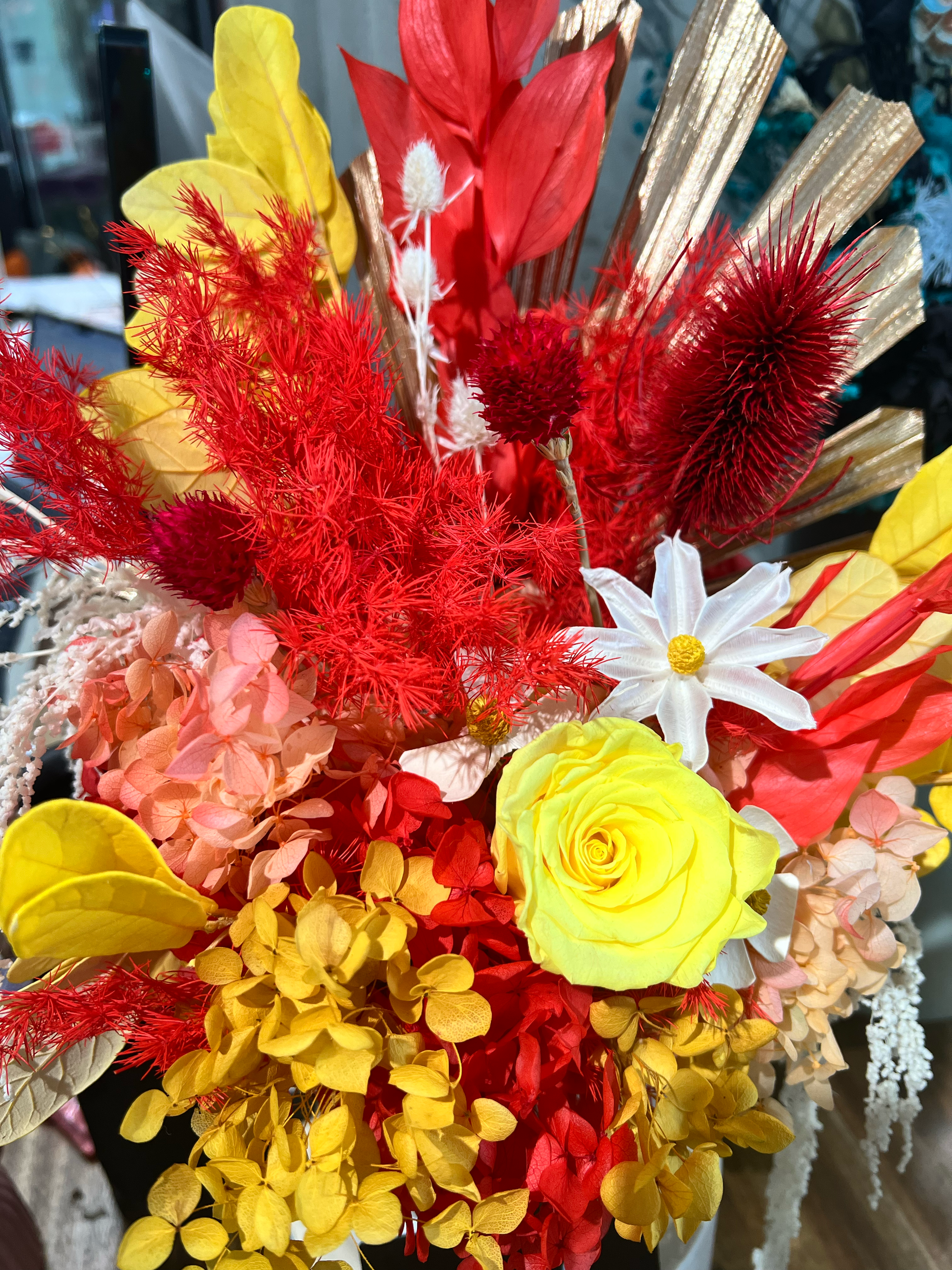 Preserved yellow roses with red and yellow hydrangeas and coordinating everlasting flowers, showcasing premium preserved floral materials for floral design.