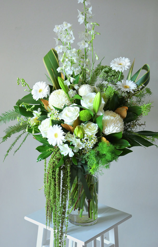 Large white and green bouquet featuring white roses, lilies, gerberas, chrysanthemums, ping pong chrysanthemums and delphiniums, handcrafted by Rosella Florist Canberra for premium flower delivery.