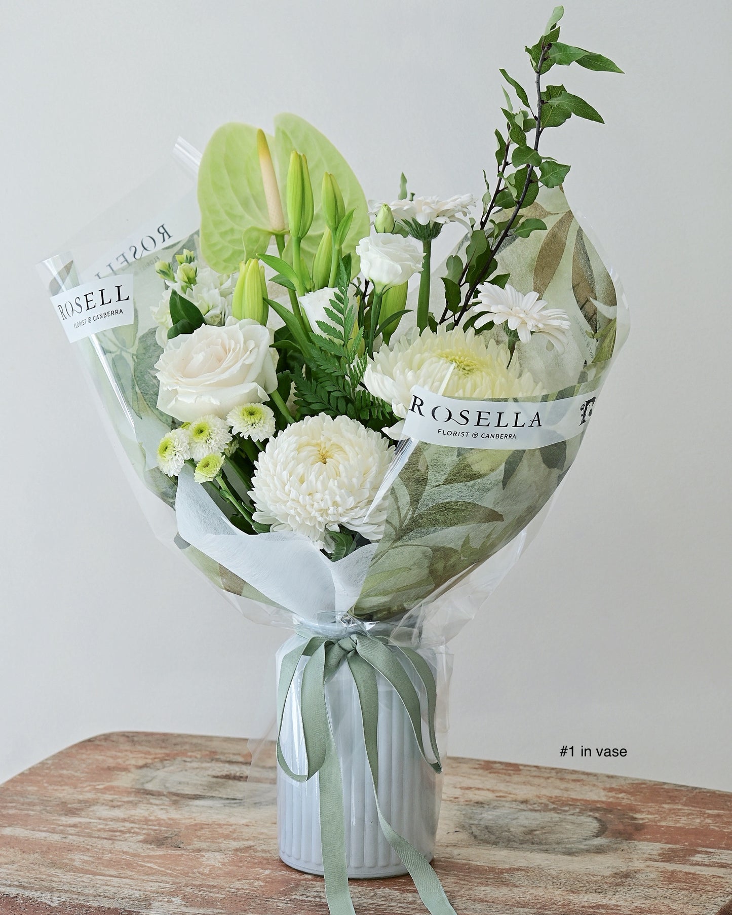 white and green flower arrangement in vase